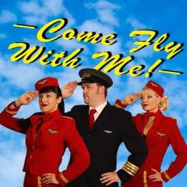 The cast of the 'Come Fly With Me' show. A pilot and two stewardesses saluting in front of a blue sky background.
