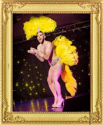Male Burlesque performers London for hire include this Boylesque dancer in yellow feathers and heels at a dancing cabaret