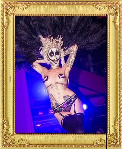London Burlesque dancer in alternative costume, skull face-paint and powdered wig