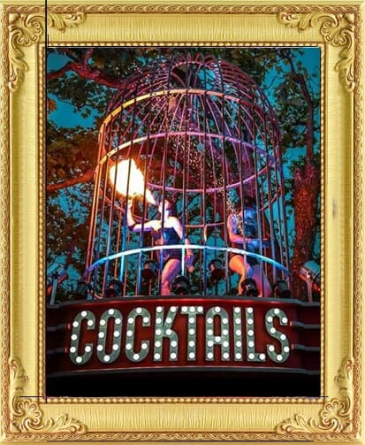 Corporate party entertainment in London and Brighton, fire performers breathe fire in a giant gold birdcage