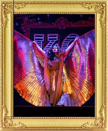 Cabaret Dancer performs with giant gold wings at corporate party entertainment in London and Brighton