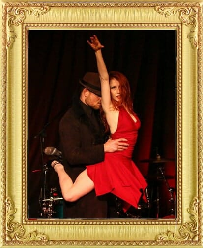 Dance performers for hire in London and Brighton, male dancer lifts female dancer in a red dress