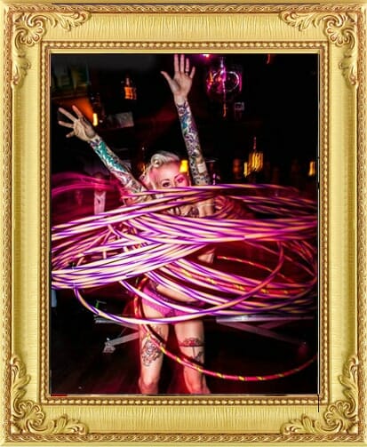 Performers for Hire Brighton & London, hula hoop performer London rotates multiple pink hoops