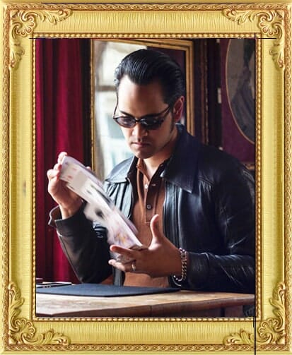 modern suave magician for hire in London and Brighton shuffles cards in Brighton cabaret show