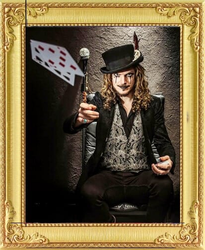 vintage magician for hire with top hat throws playing cards for corporate event entertainment London