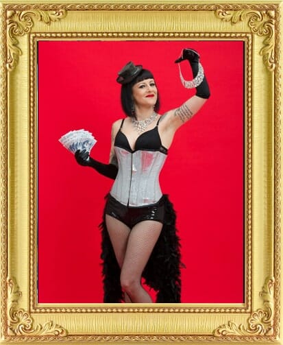 burlesque performer in silver corset holding diamonds from our events agency London and Brighton.