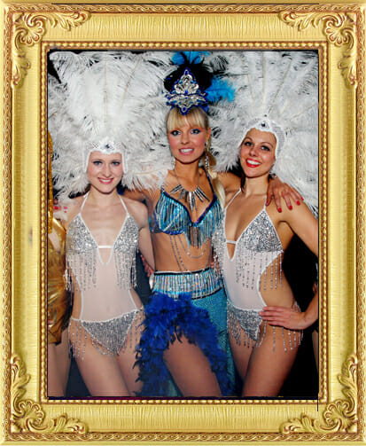 Trio of showgirls pose in feather costumes as entertainment from our entertainment agency Brighton