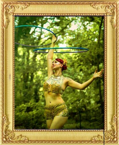 cabaret dancer in gold beaded costume spinning hoops for our entertainment agency Brighton