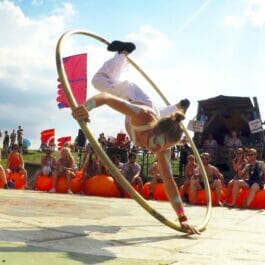 Cyr wheel performer at an outdoor family event in Brighton